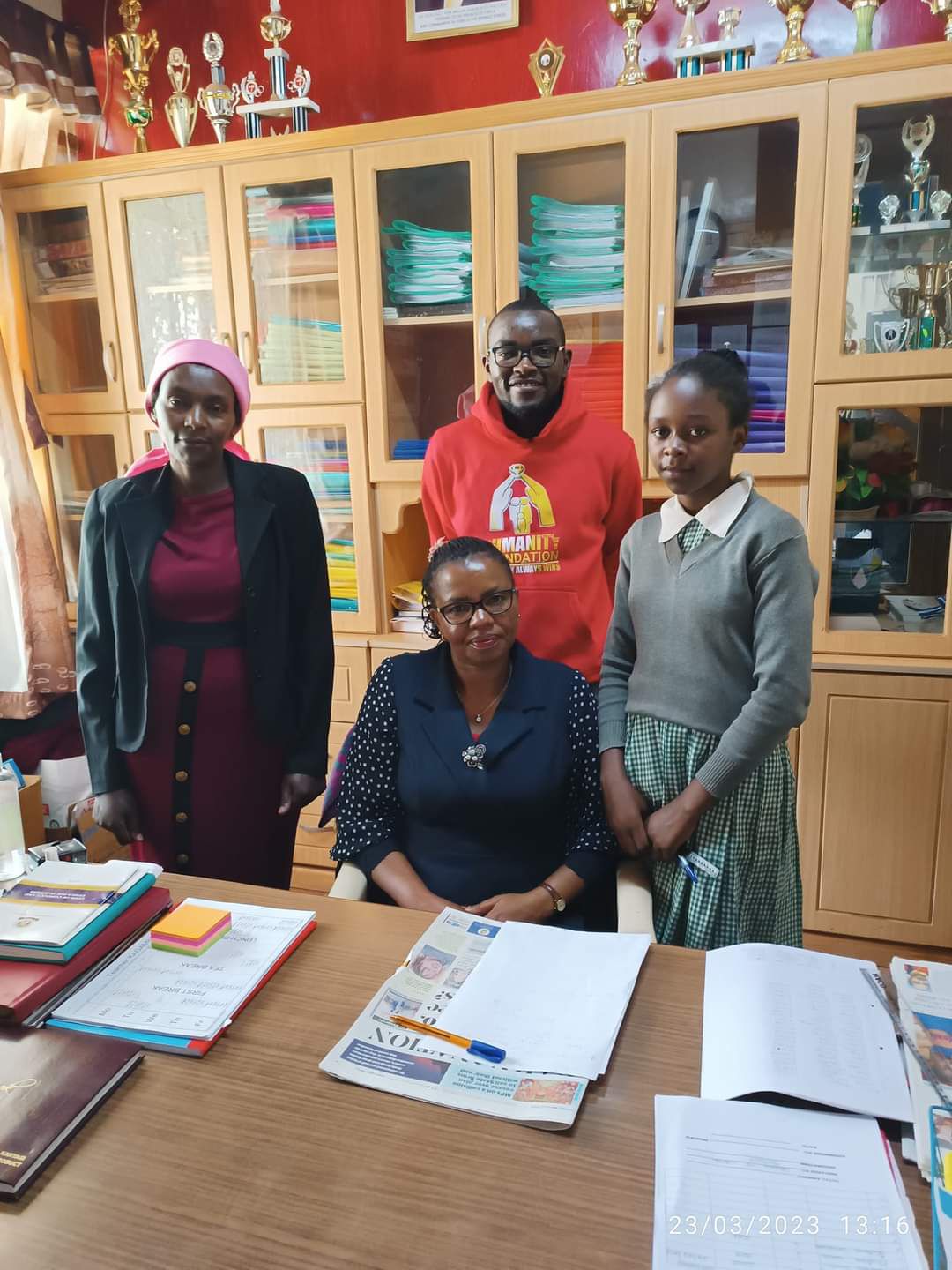 At the Principal's office, alongside her mum and our team leader.