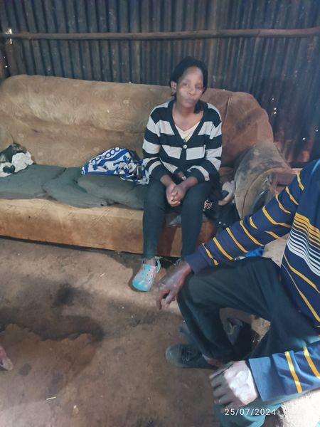 Husband and wife inside their dilapidated house